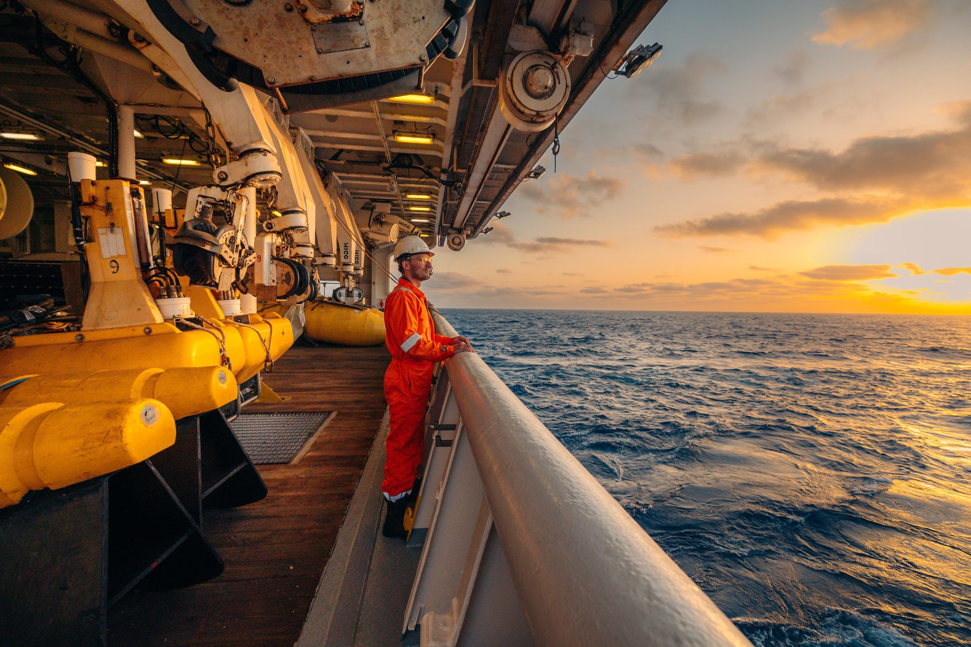 Furkan on the deck of a seismic survey vessel at sunset